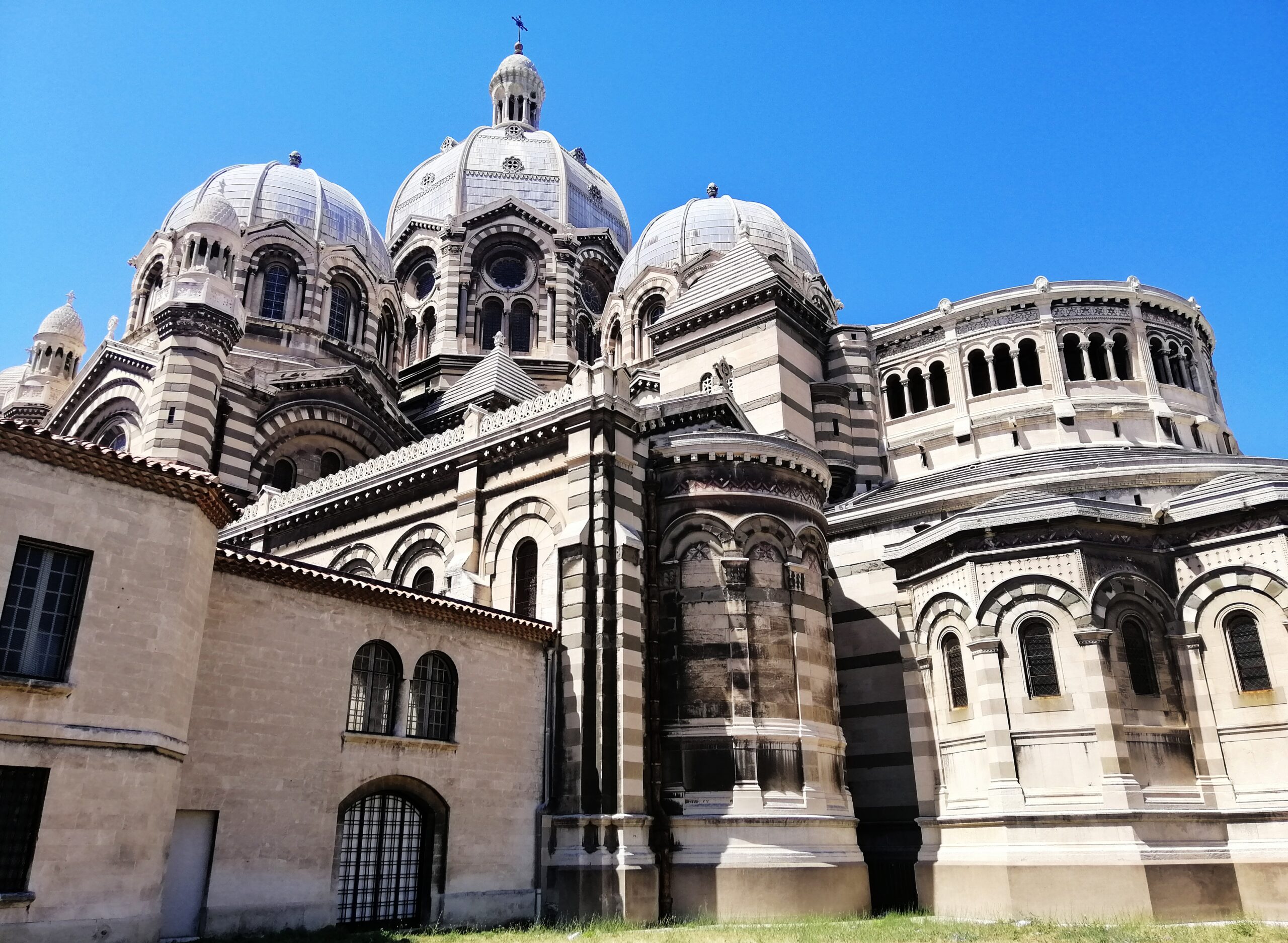 A low angle view of the Marseille Cathedral under the sunlight and a blue sky in France