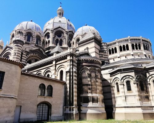 A low angle view of the Marseille Cathedral under the sunlight and a blue sky in France